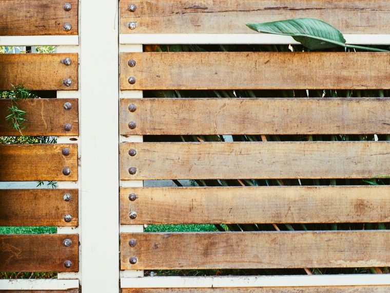 Horizontal timber slat fence with white posts