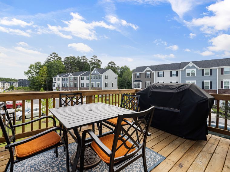 Timber deck with patio table, chairs and a grill